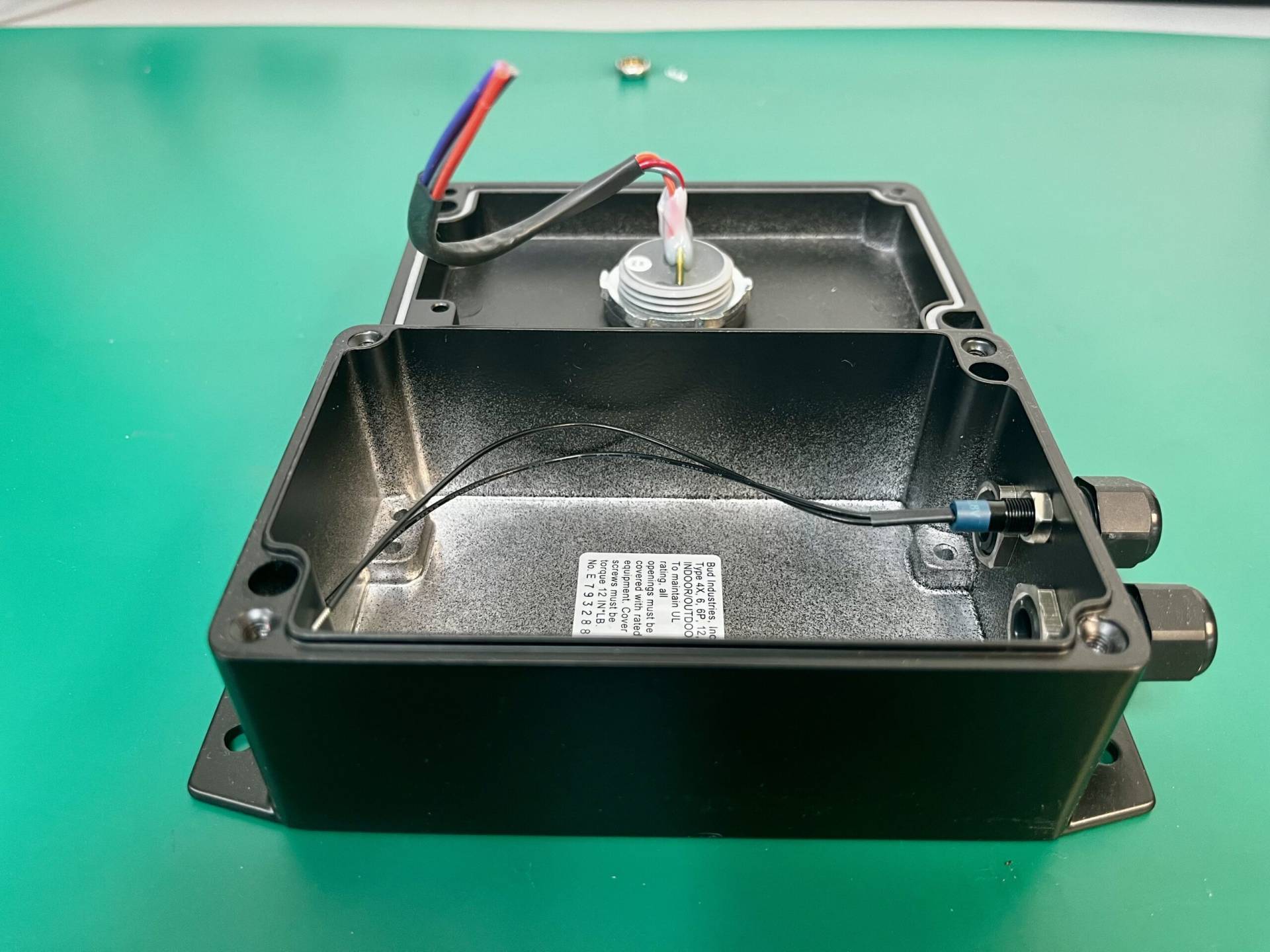 Open black enclosure box showing internal wiring and cable connections, designed for electronic component housing at MAKS Inc.